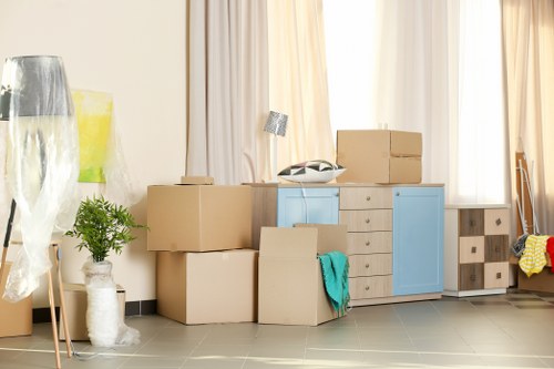 Moving van and packed boxes outside a Putney home