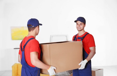 Removal team carefully loading furniture for a Putney house move