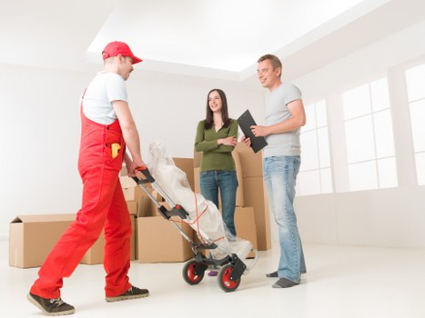 Removal team packing furniture for a Putney home move