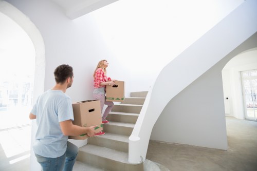 Professional movers loading items for a house move