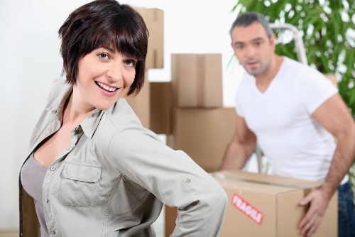 Trained moving staff using PPE while lifting furniture carefully