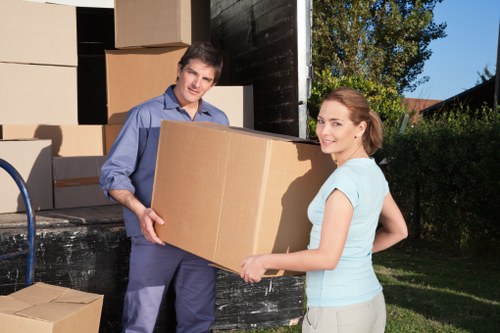 Two movers carrying furniture during a relocation